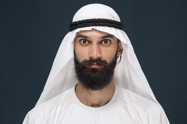portrait of arabian saudi sheikh. Young male model posing and looks serious or calm.