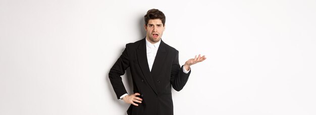 Free photo portrait of arrogant man in black suit looking confused and disappointed complaining about something