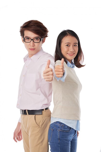 Portrait of Asian boy and girl standing back to back thumbs up