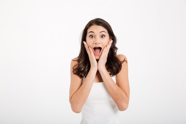 Portrait of an astonished woman dressed in tank-top