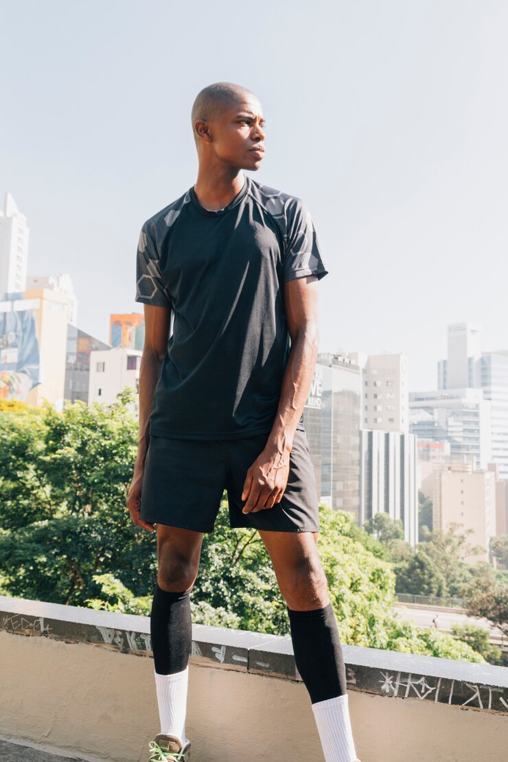 Free Photo portrait of a athlete male runner standing on rooftop