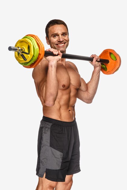 Portrait of athletic shirtless middle age man with barbell isolated on white background.