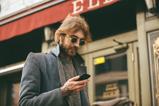 Portrait of an attractive bearded man in earphones