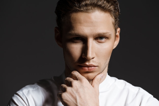 Portrait of attractive caucasian man over grey wall