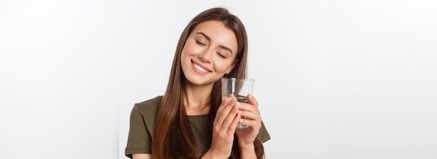 Free photo portrait of attractive caucasian smiling woman isolated on white studio shot drinking water