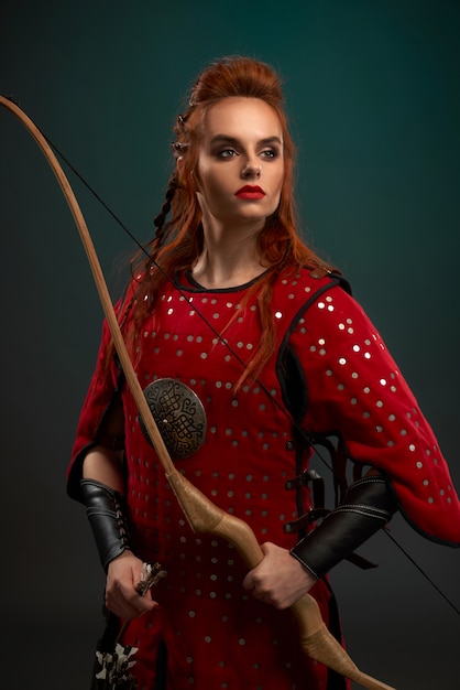 Portrait of attractive female warrior wearing red armor