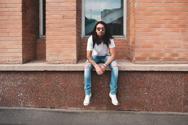 Portrait attractive man near window on urban scene