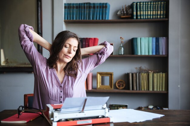 Portrait of an attractive woman authoress resting and stretching hands