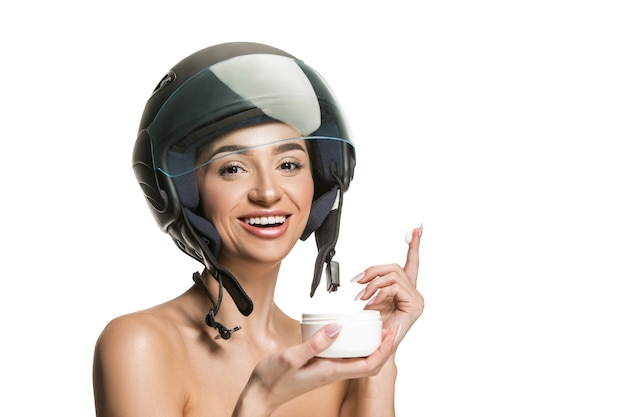 Portrait of attractive woman in motorbike helmet on white studio