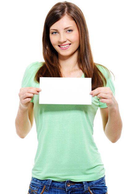 Portrait of an attractive young adult woman holding blank card