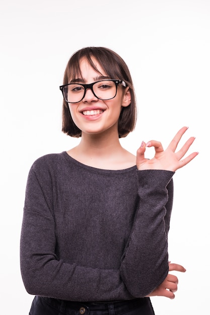 Portrait of attractive young teen girl showing okay