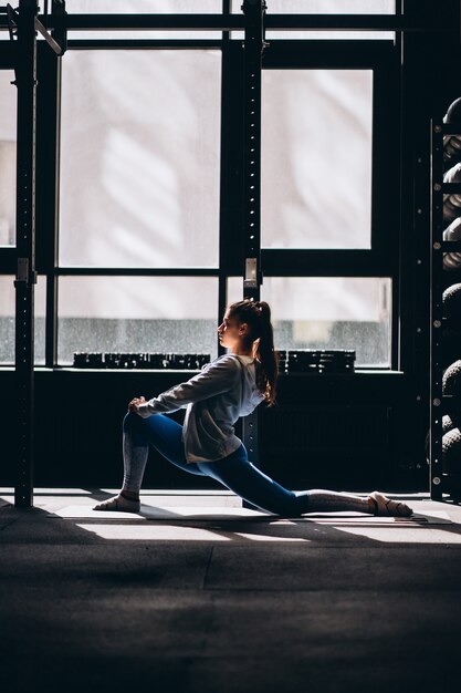 Portrait of attractive young woman doing yoga or pilates exercise