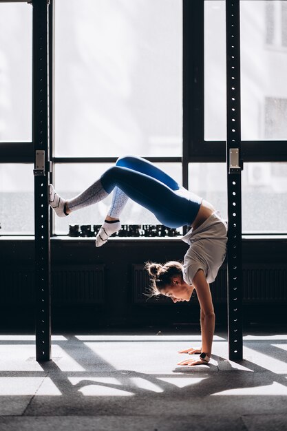 Portrait of attractive young woman doing yoga or pilates exercise