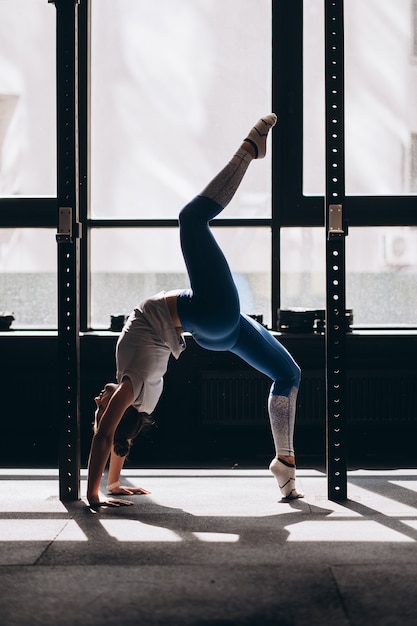 Portrait of attractive young woman doing yoga or pilates exercise