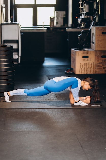 Portrait of attractive young woman doing yoga or pilates exercise