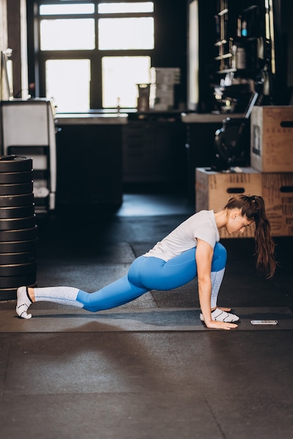 Portrait of attractive young woman doing yoga or pilates exercise