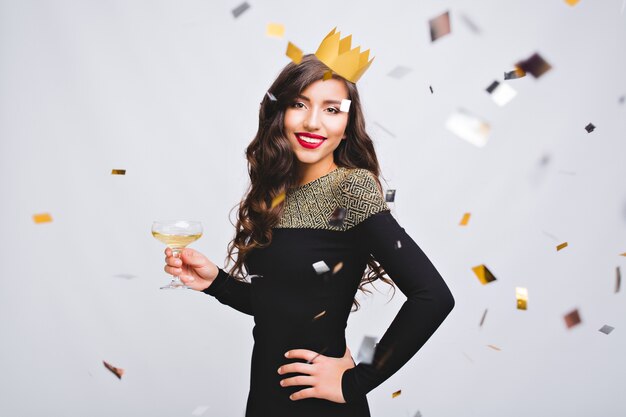 Portrait attractive young woman with yellow crown celebrating birthday party on white space.