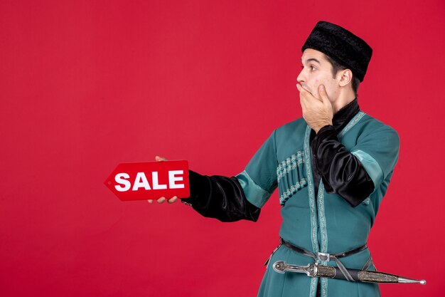 Portrait of azeri man in traditional costume holding sale nameplate redshopping spring novruz