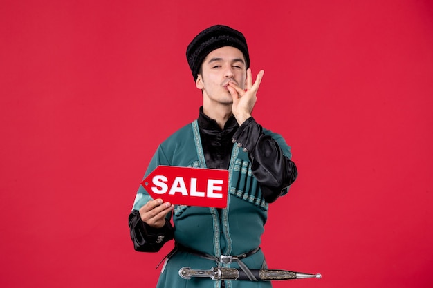 Free photo portrait of azeri man in traditional costume holding sale