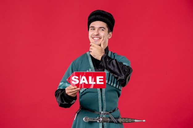 Portrait of azeri man in traditional costume holding sale