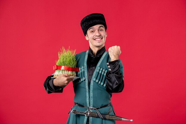 Portrait of azeri man in traditional costume holding semeni studio shot red novruz performer dancer