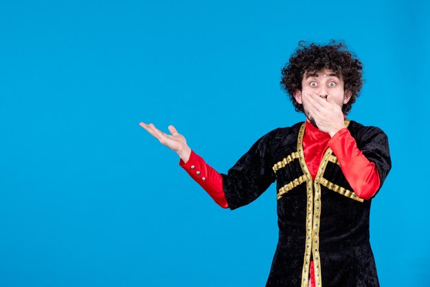 Portrait of azeri man in traditional costume studio shot blue background ethnic dancer spring concept novruz photo