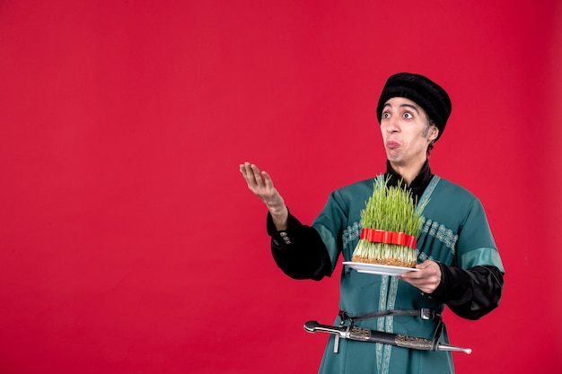 Portrait of azeri man in traditional costume with semeni on red dancer ethnic novruz holiday spring