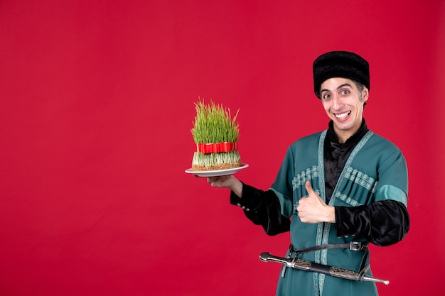 Portrait of azeri man in traditional costume with semeni on red dancer holiday novruz ethnic spring color