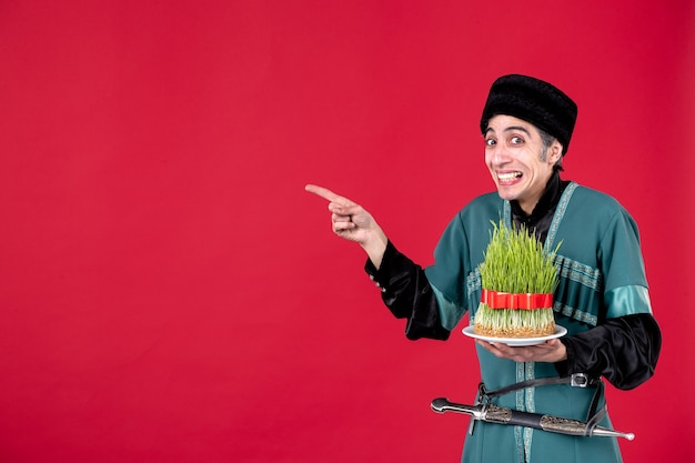 Portrait of azeri man in traditional costume with semeni on red novruz ethnic holiday dancer