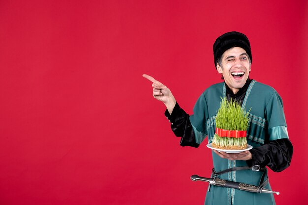 Portrait of azeri man in traditional costume with semeni on red novruz ethnic spring dancer