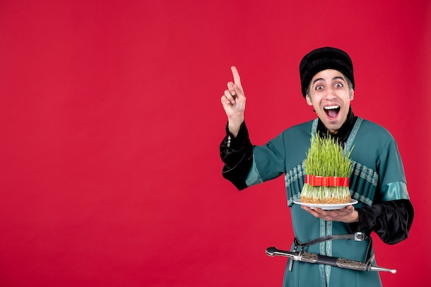 Portrait of azeri man in traditional costume with semeni on red spring novruz ethnic dancer