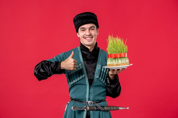 Portrait of azeri man in traditional costume with semeni on red