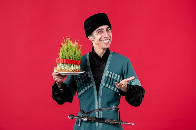 Portrait of azeri man in traditional costume with semeni on red