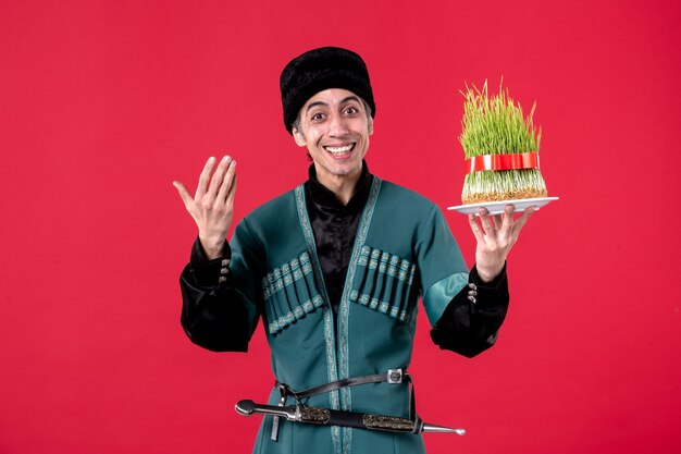 Portrait of azeri man in traditional costume with semeni on red