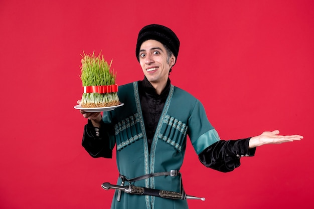 Portrait of azeri man in traditional costume with semeni on red