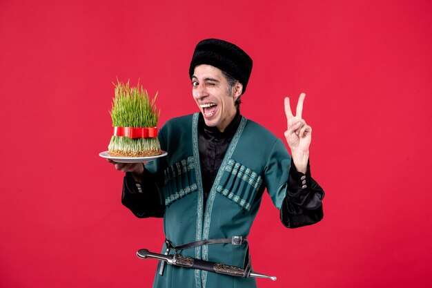 Portrait of azeri man in traditional costume with semeni on red