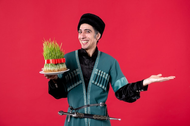 Free photo portrait of azeri man in traditional costume with semeni on red