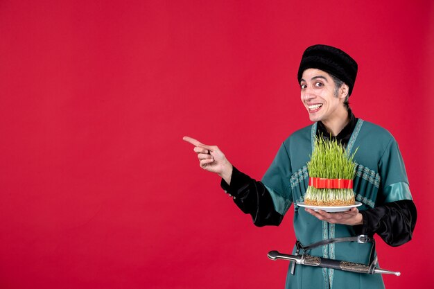 Portrait of azeri man in traditional costume with semeni on red