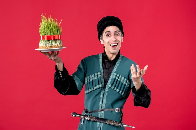 Portrait of azeri man in traditional costume with semeni on red