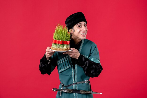 Portrait of azeri man in traditional costume with semeni on red