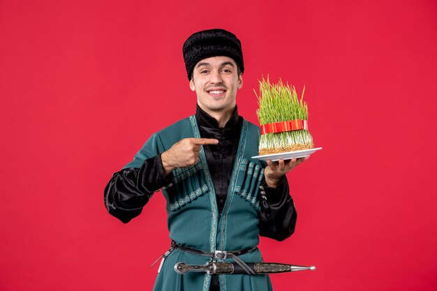 Portrait of azeri man in traditional costume with semeni on red