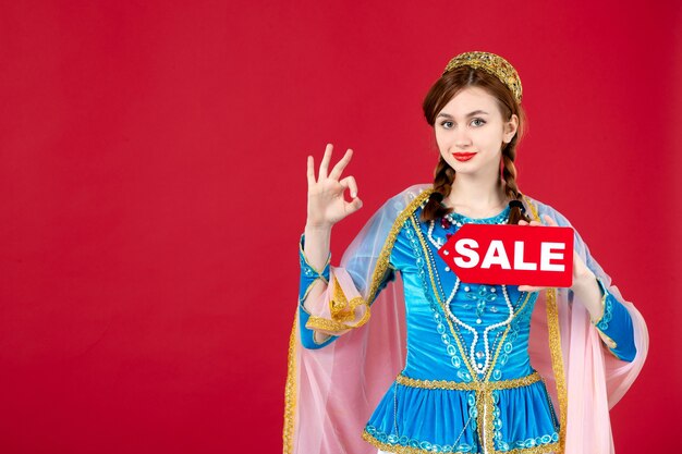 빨간색에 판매 명판을 들고 전통적인 드레스에 아제리 여자의 초상화