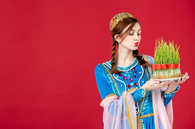 Free photo portrait of azeri woman in traditional dress with semeni on red