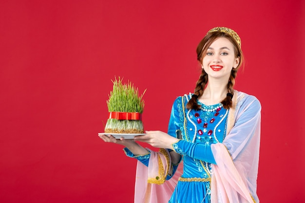 Free photo portrait of azeri woman in traditional dress with semeni on red