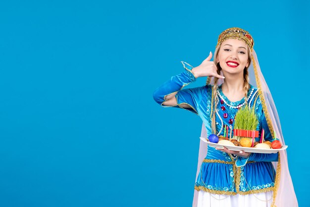 Portrait of azeri woman in traditional dress with xonca studio shot blue background concept dancer spring novruz ethnic photo