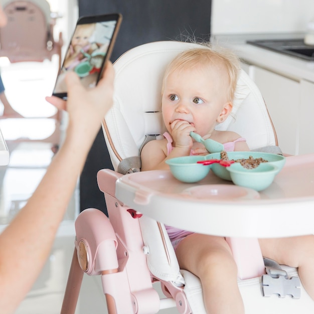 Portrait of baby girl in highchair