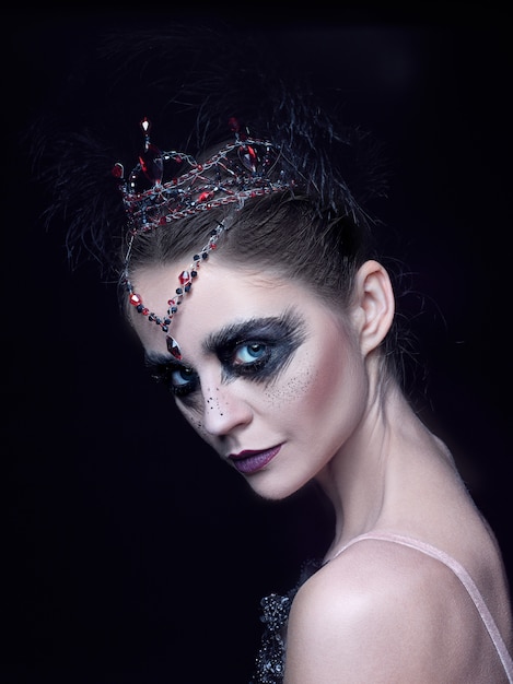 Portrait of ballerina as swan on black