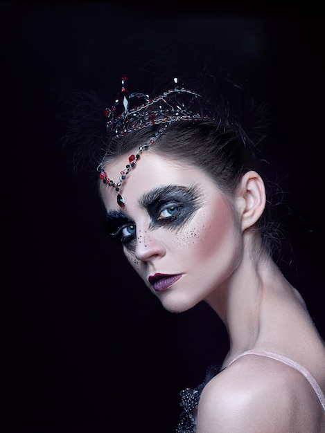 Portrait of ballerina as swan on black