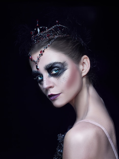 Portrait of ballerina as swan on black