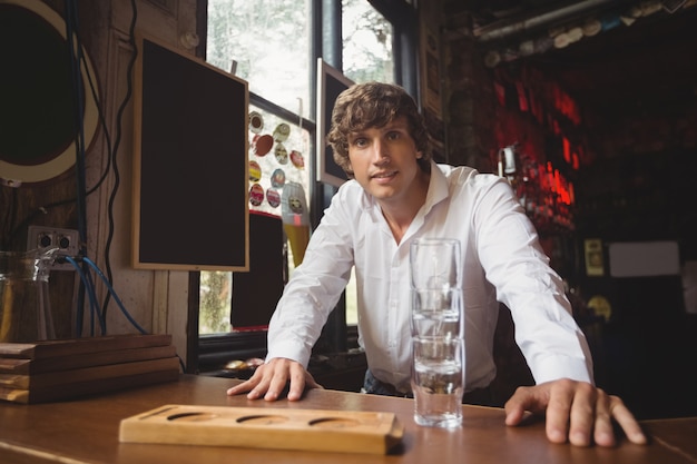 Portrait of bartender at bar counter